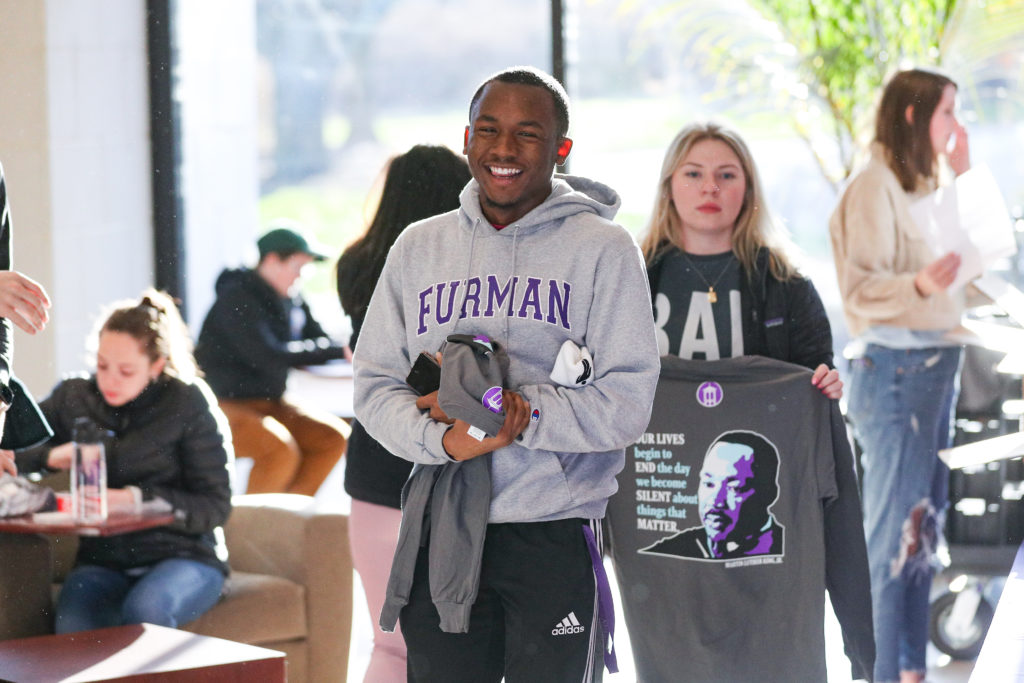Student smiling with a Furman sweatshirt