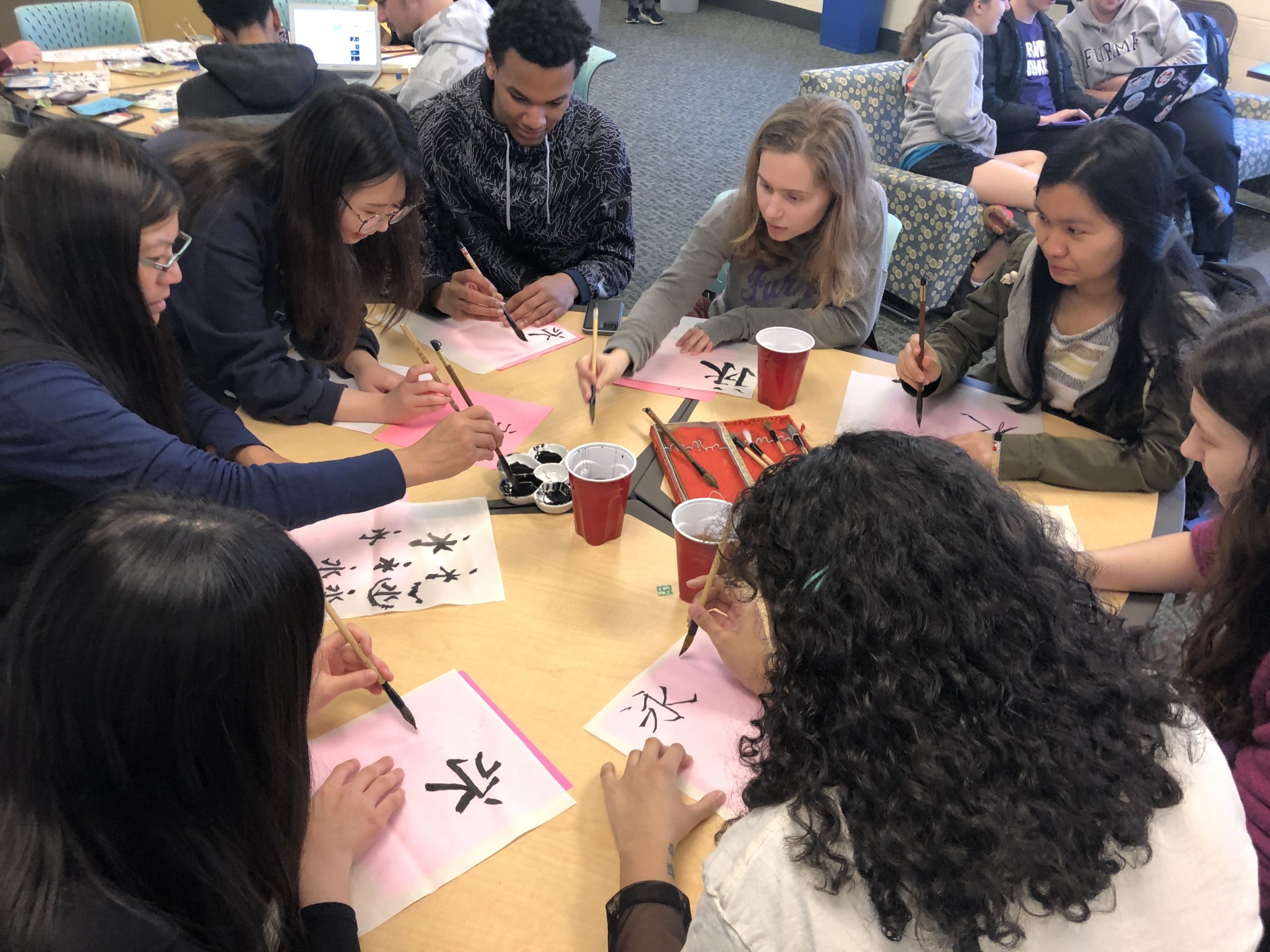 Students working on calligraphy