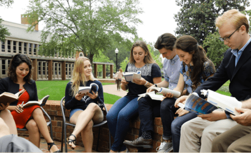 Politics students sit outside reading together at Furman