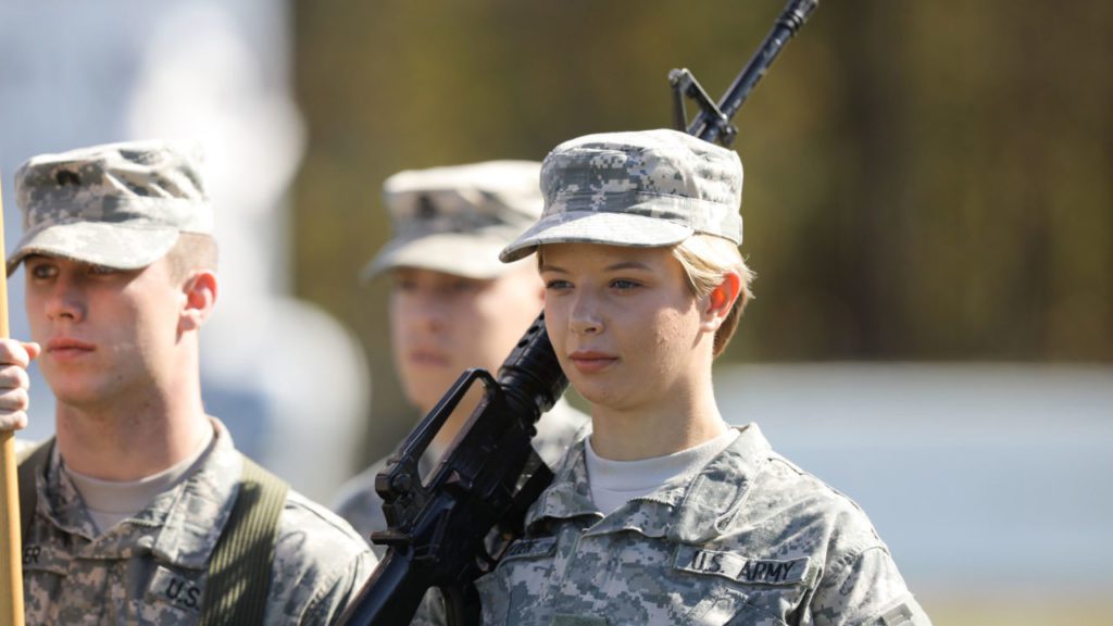 ROTC student wearing uniform and holding gun