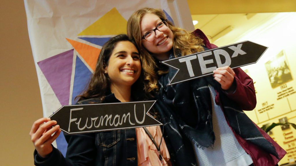 students holding TedX signs