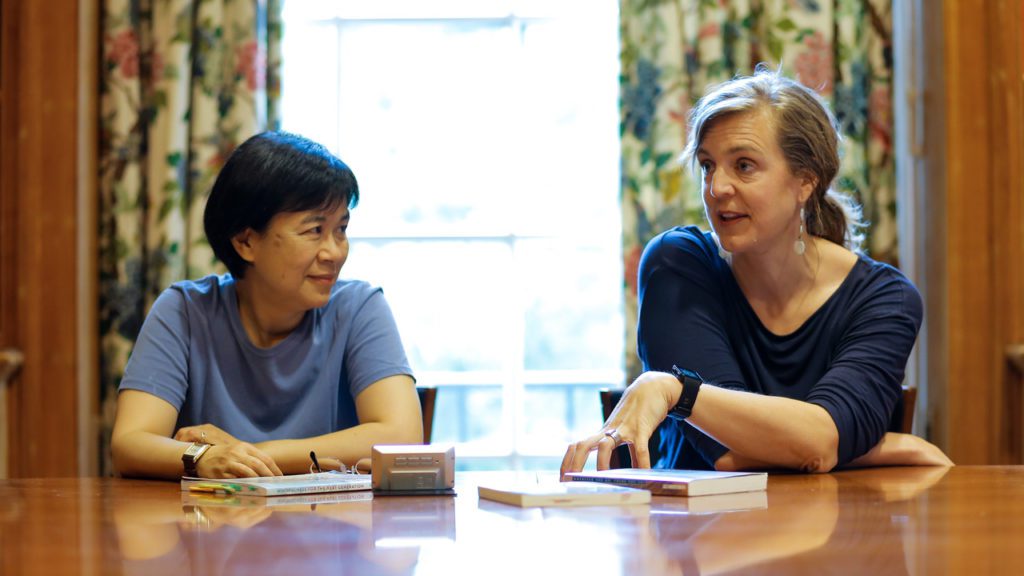 Biology professors laugh in an active learning workshop