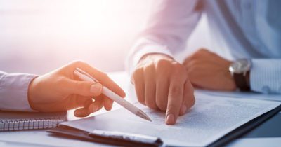 Student pointing to paper with pen