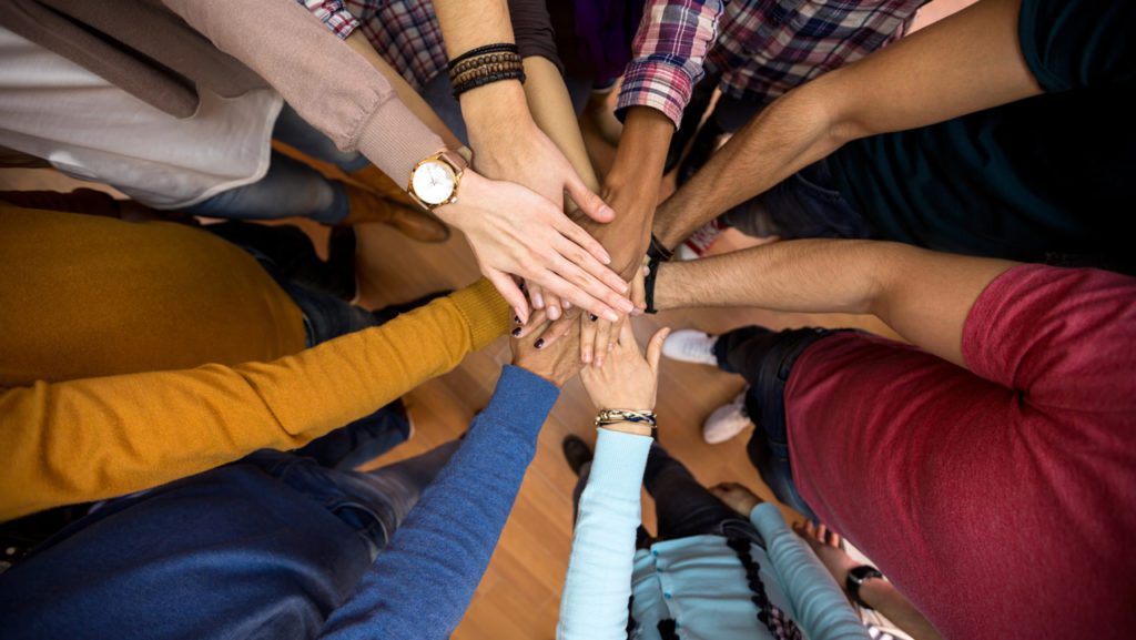 Hands reaching into a center