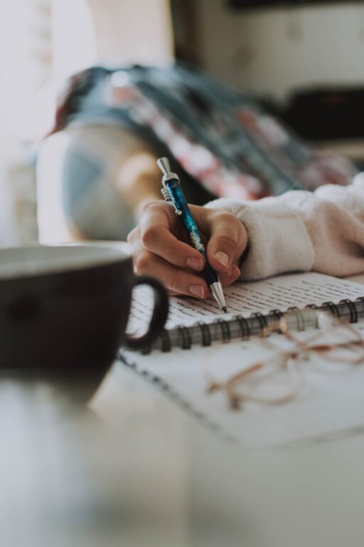 Person writing on a piece of paper.