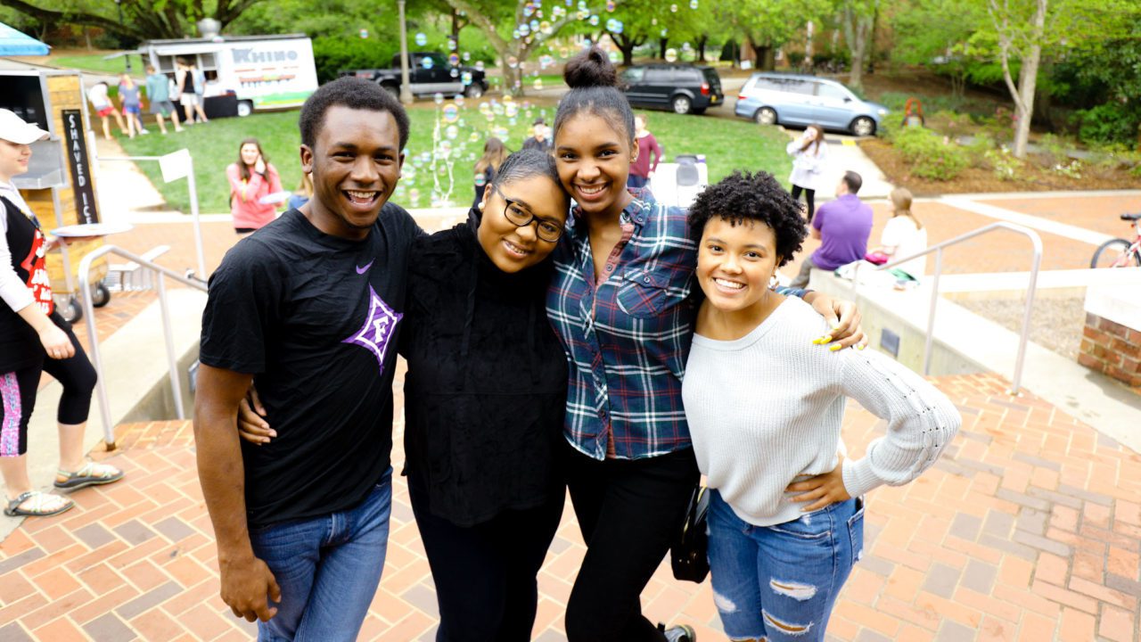 Students attending a fair on Furman campus, all smiling