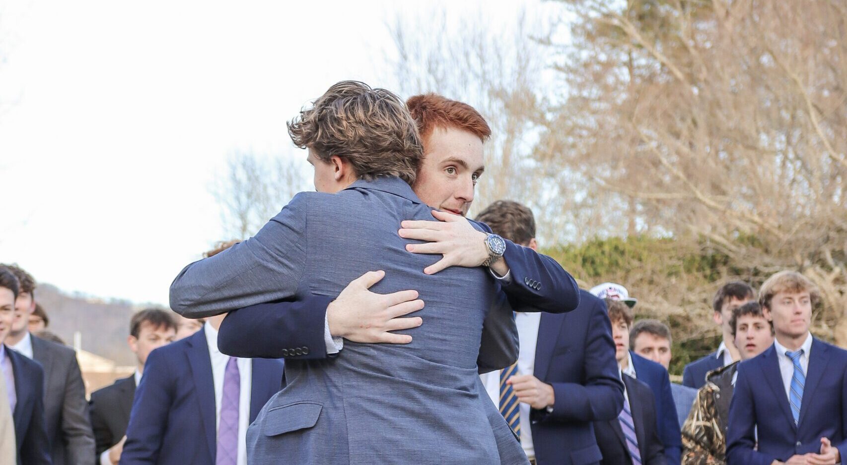 Fraternity brothers hugging on bid day