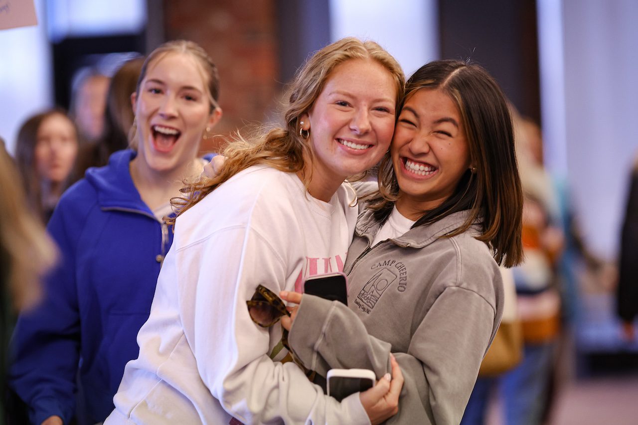 Women smiling for picture on bid day