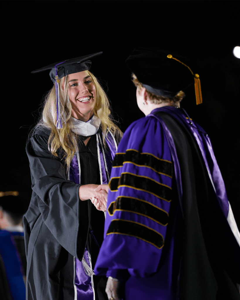Female student receiving diploma
