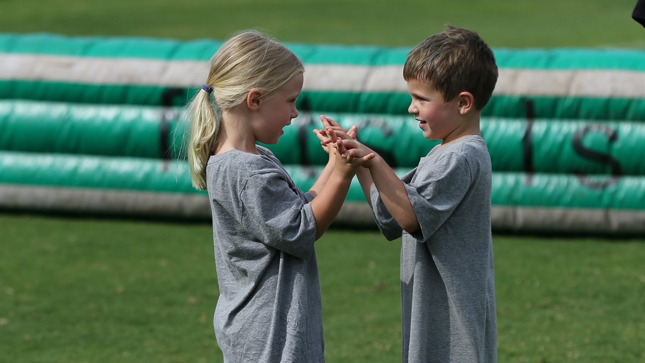 Kids holding hands at camp