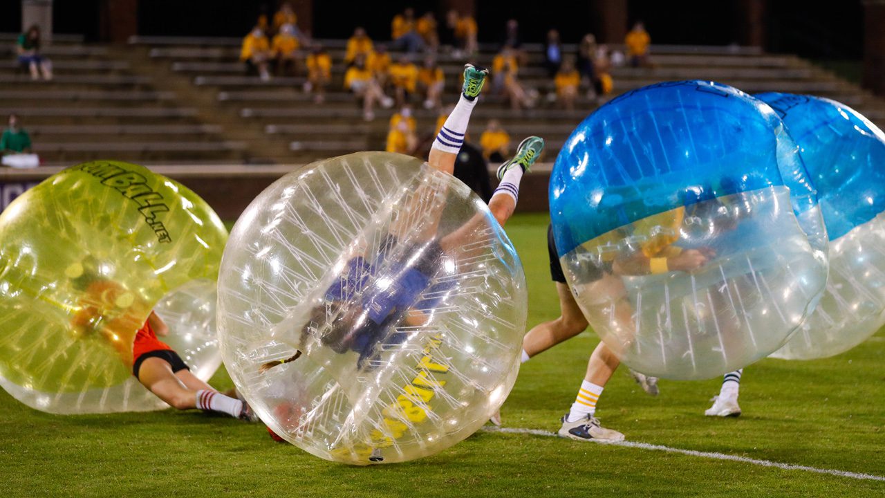 Students on field in blow up balls
