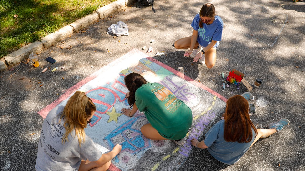 Students drawing with chalk