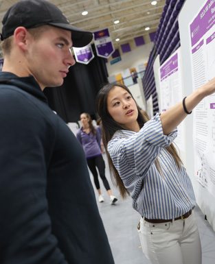 Furman student pointing to a display