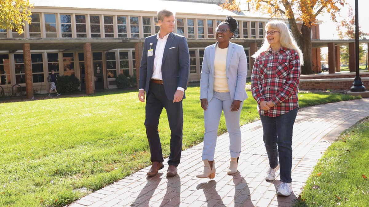 Kirby Mitchell '90 and Melanie Maloney walk and talk on the Furman campus