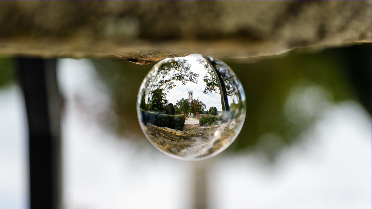 Glass ball reflecting bell tower