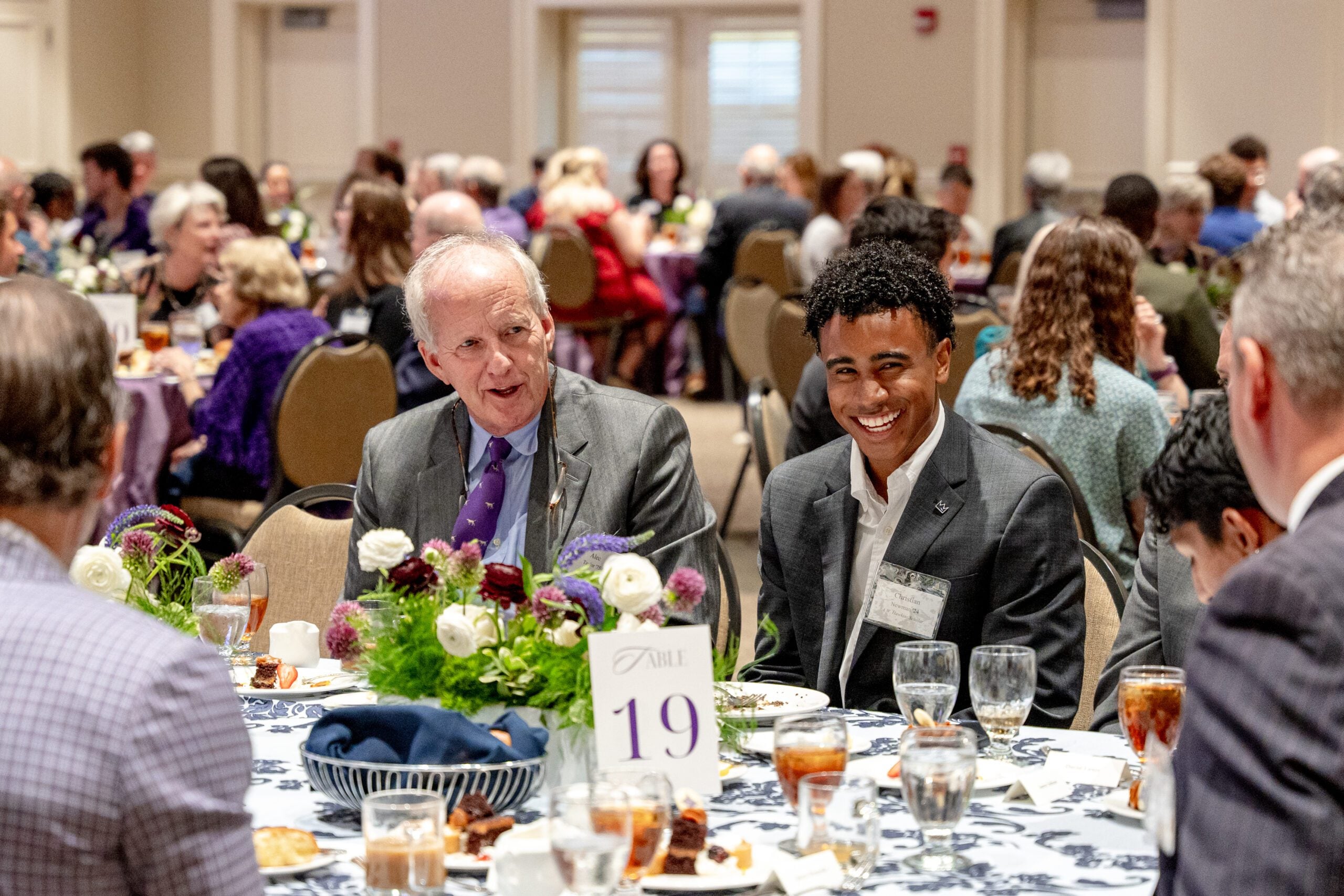 two people laughing at a luncheon