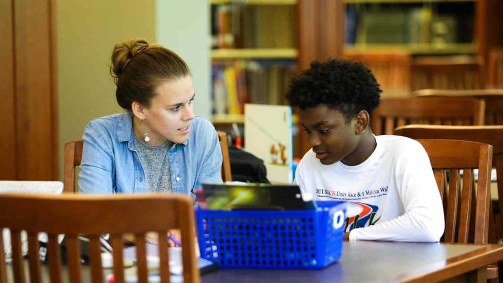 Student and teacher in the library