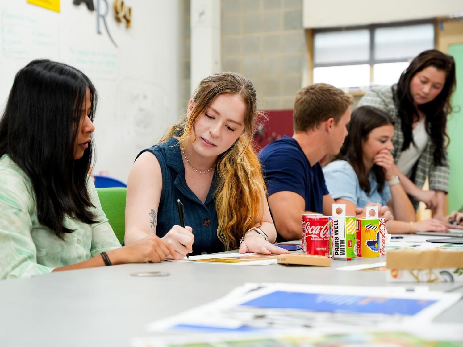 Design students drafting at large table