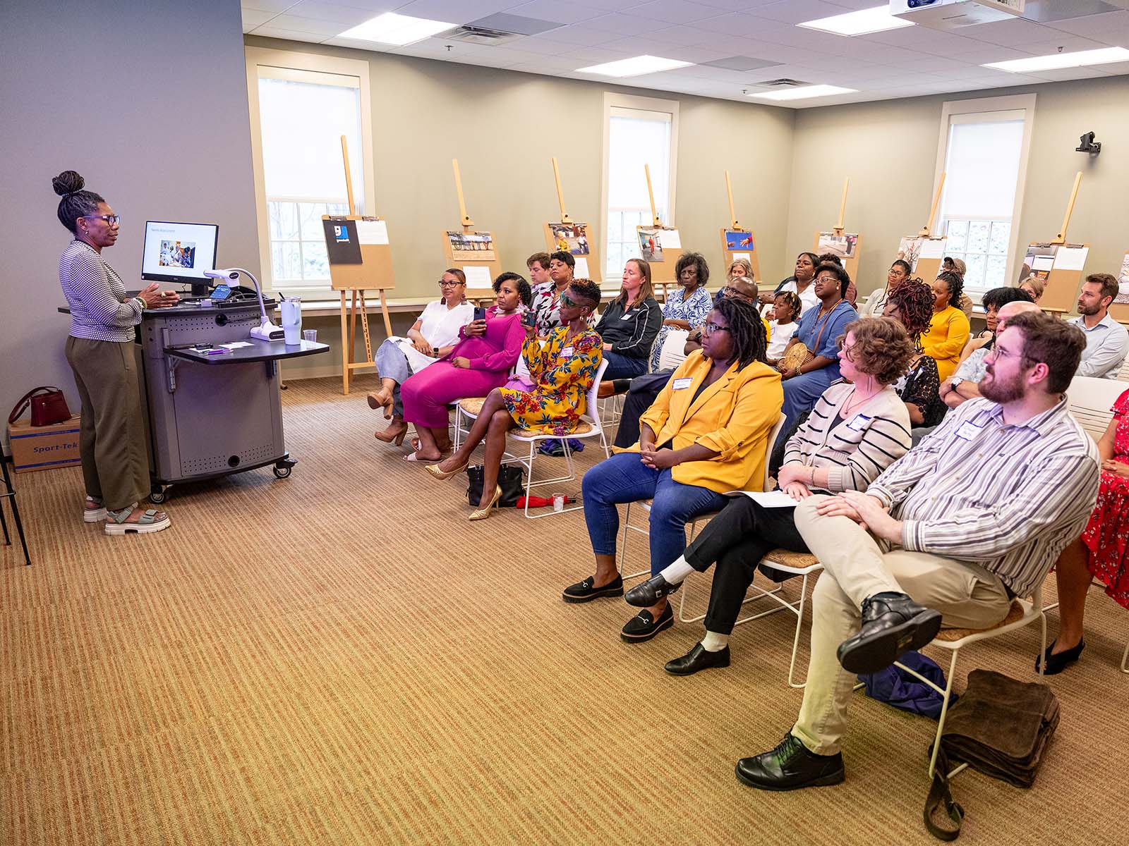 Dr. Judith Williams addresses attendees of Photovoice student presentation