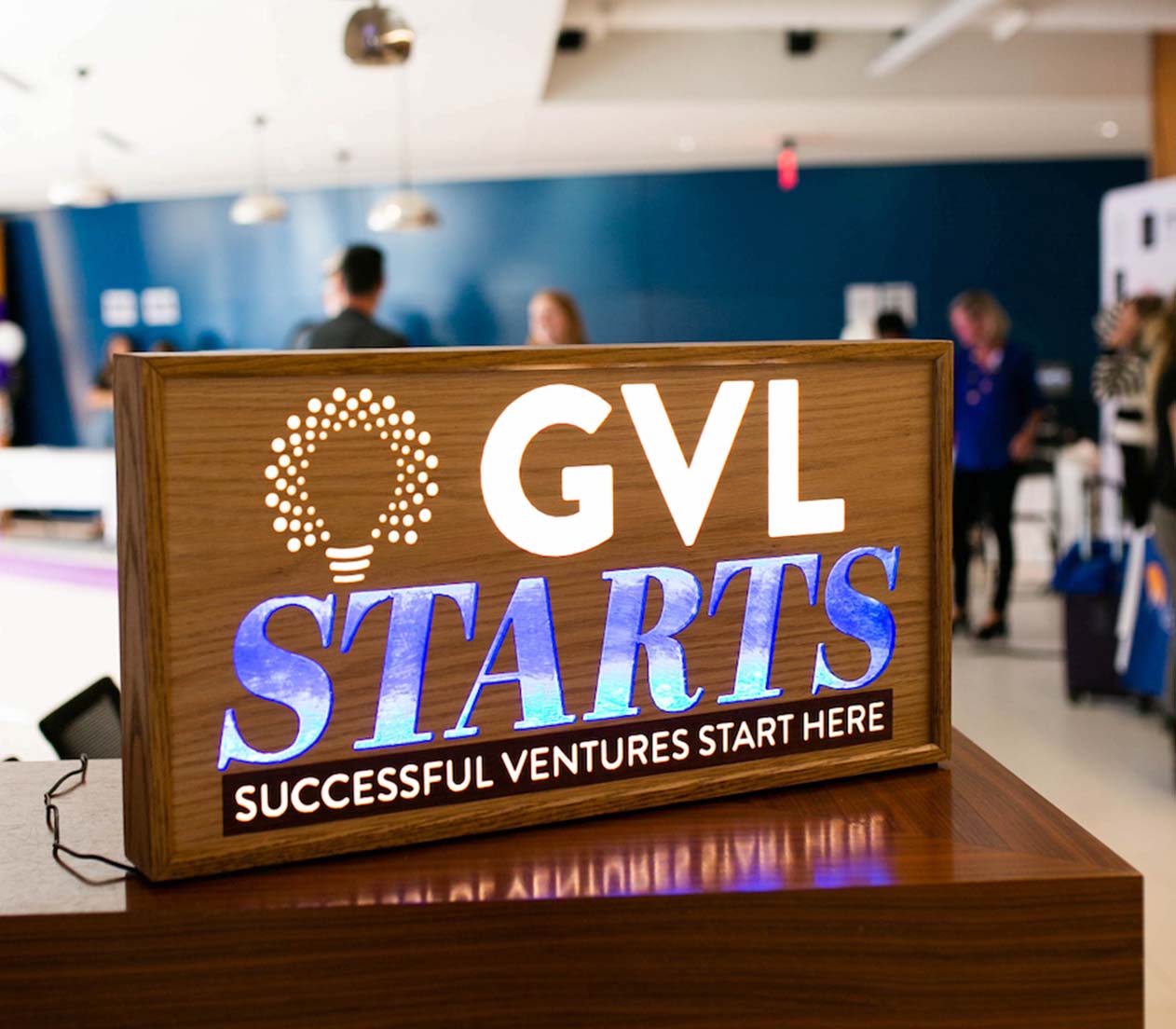 GVL Starts sign on a table in a room full of people