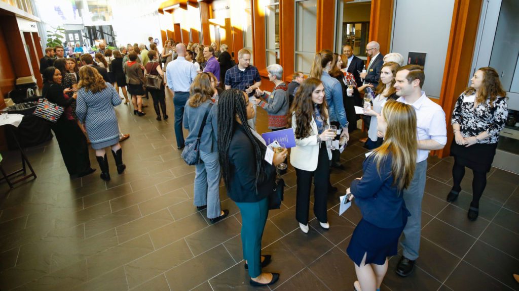 Students milling about at an event for IACH