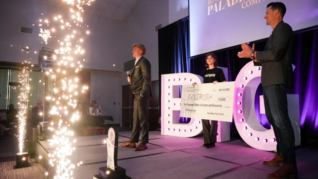 Stage at Paladin Pitch Competition with large “BIG” letters, sparklers, and an oversized check presentation.