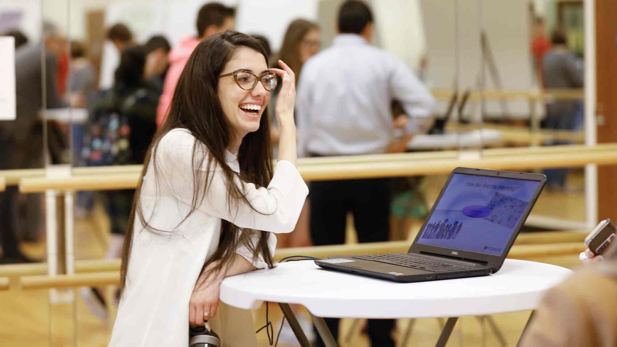 Student tucking hair behind hair and reading powerpoint slides