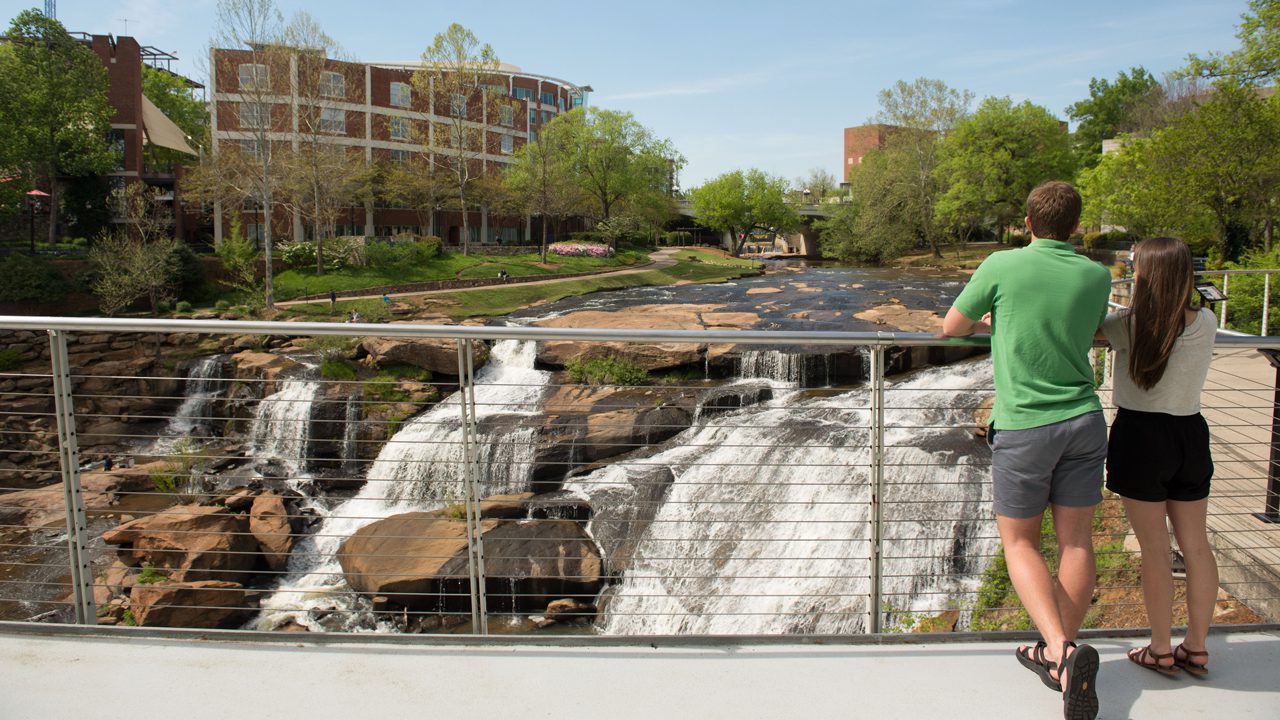Students looking over the Reedy River in Greenville