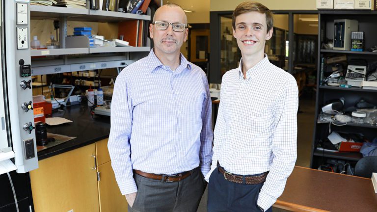 Greg Springsteen and Trent Stubbs stand in a chemistry department office|Trent Stubbs '20 and Greg Springsteen in a lab