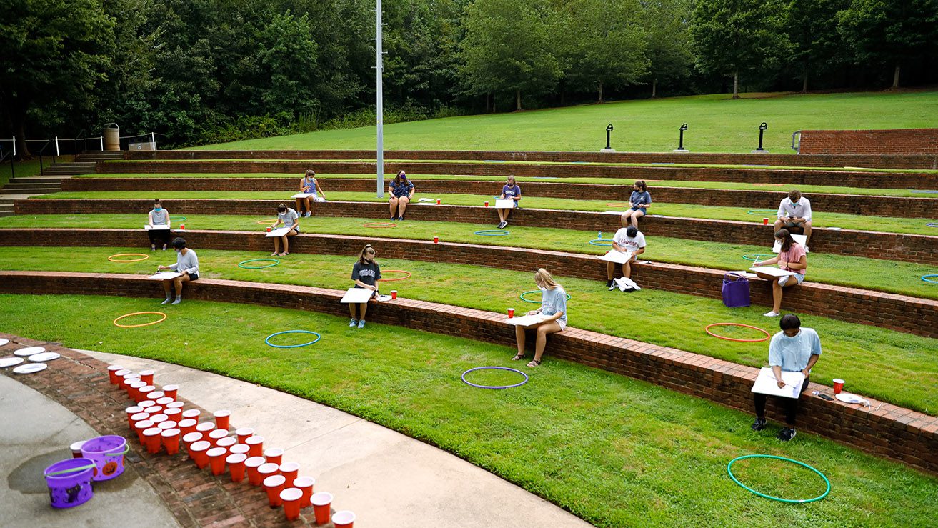 Students take a painting class in the Lakeside Amphitheater