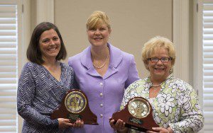 President Elizabeth Davis honors Emily Sweezey (left) and Linda Ray (right) during an April 17 ceremony. 