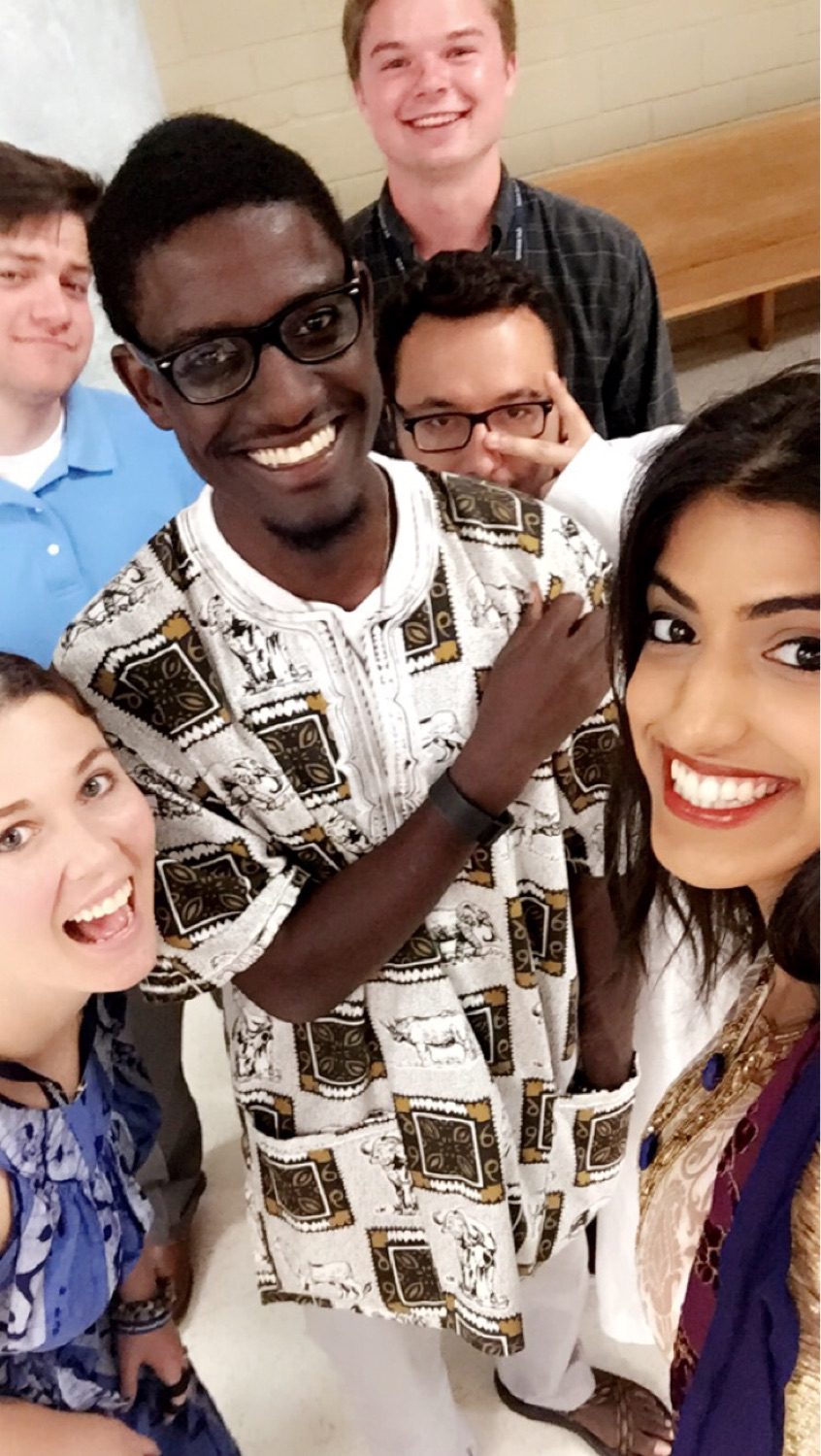 Alexi Muhumure (center) and fellow interns celebrate World Refugee Day