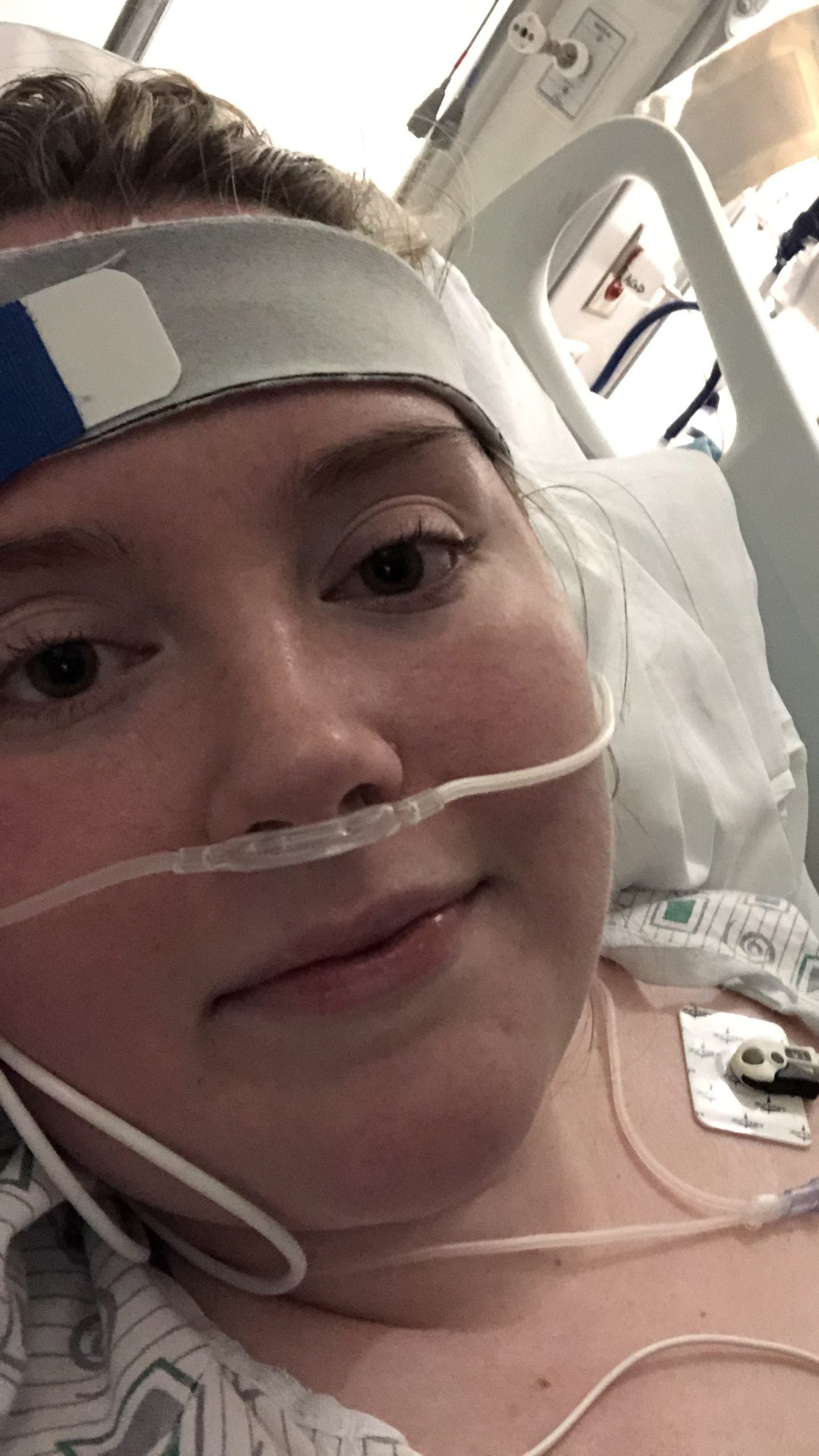 Selfie of a woman in a hospital bed.
