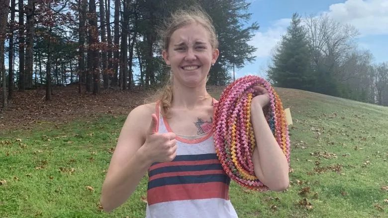 Elizabeth Allen ’20 M’22 poses with her Guinness World Record-winning chain made of 10,000 Starburst wrappers.