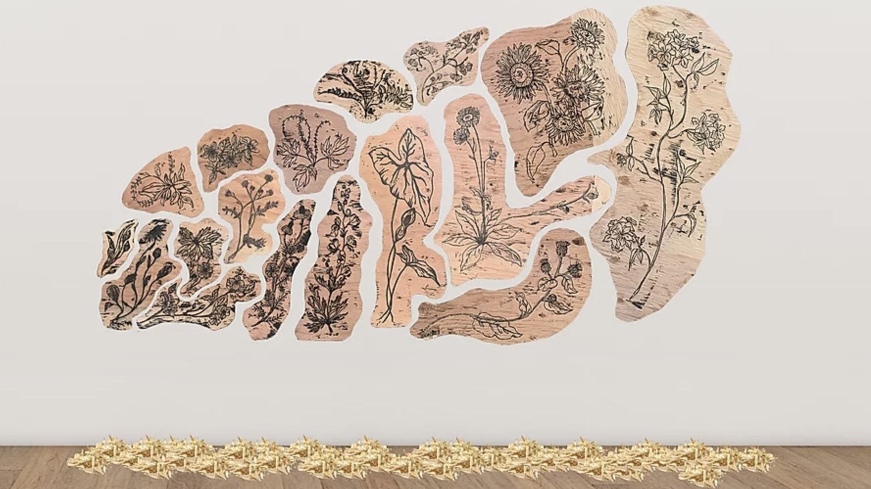 Photo of flower prints on wood arranged on a wall like a giant leaf.