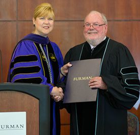 Jerry Thomas, a 1963 Furman graduate, received the honorary degree from President Elizabeth Davis.