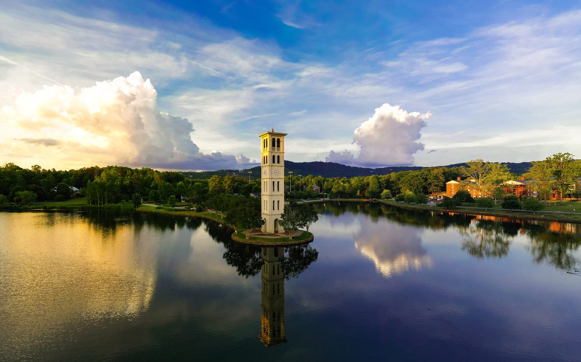 bell tower at lake with clouds in background