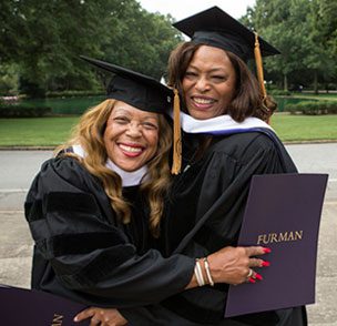 Sarah Reese (left) and Lillian Brock Flemming enjoy their honorary degrees.