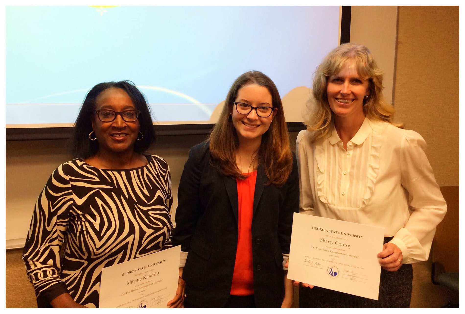 Two GSU staff members receive their certificates after successfully completing the Georgia State Staff Sustainability Certification Training.