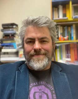 white man with beard wearing blue sport coat, Darren Hick