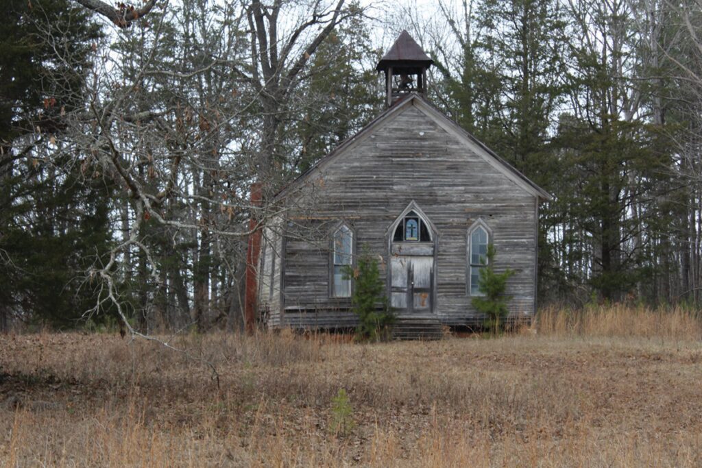 an old church in a field