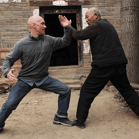 two men practice kung fu