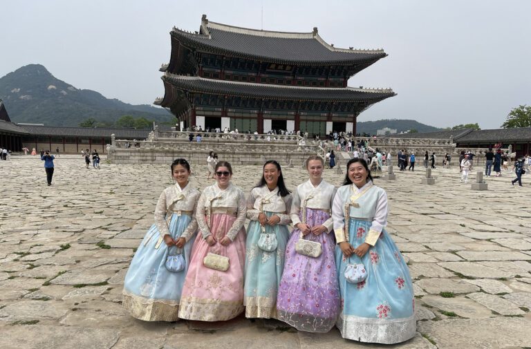 Elizabeth Gordon '23 (second from left) and colleagues, wearing traditional clothing known as "hambok," outside Gyeongbokgung Palace in Seoul, South Korea, in the summer of 2022.