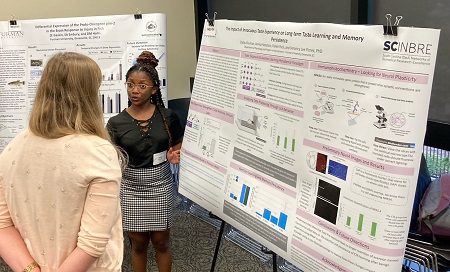 Black woman presenting poster, Dallas Shuman '25
