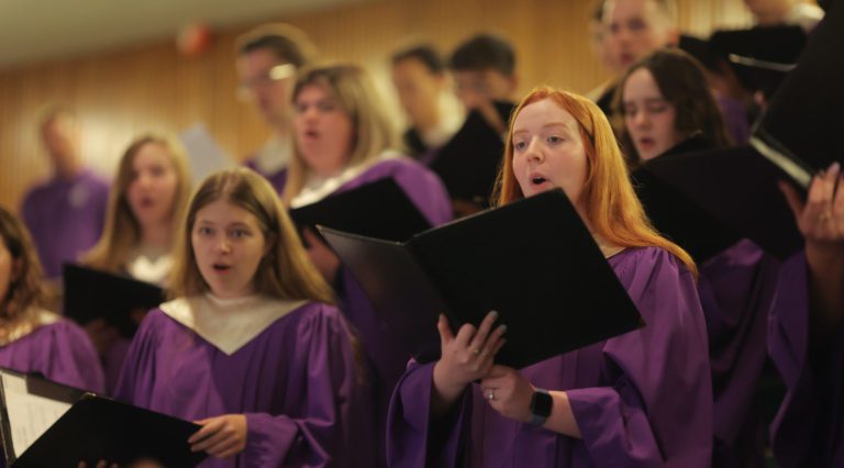 chorus of men and women in purple robes