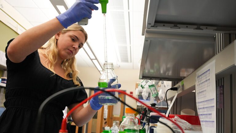 A female student works in a chemistry lab.
