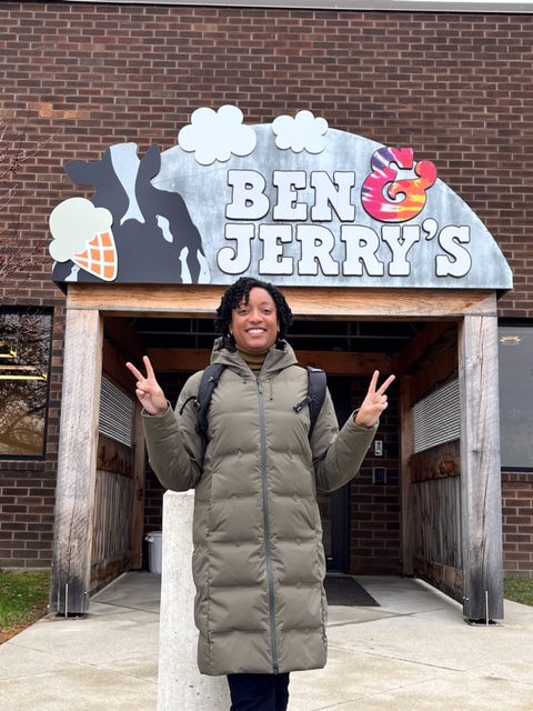 A woman in a winter parka stands outside the Ben & Jerry's offices.