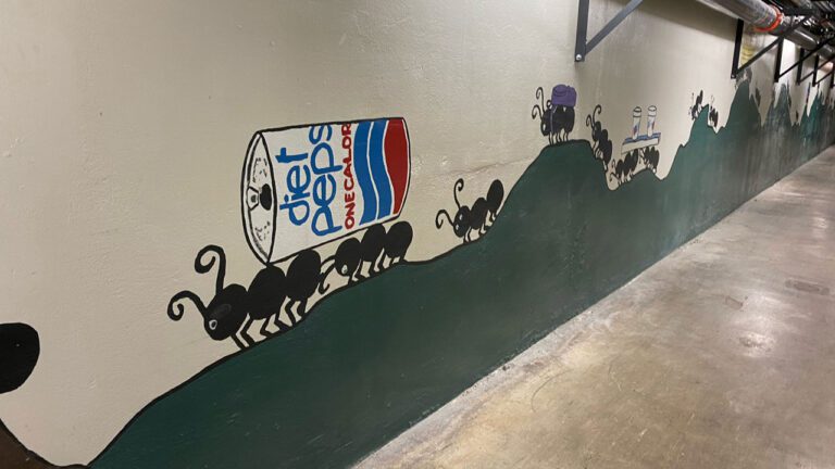 wall painting of ants carrying a diet pepsi can on their backs