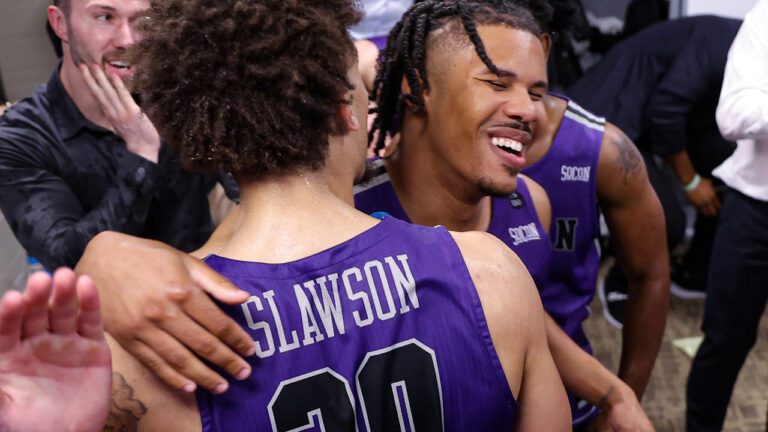 two furman basketball players embrace