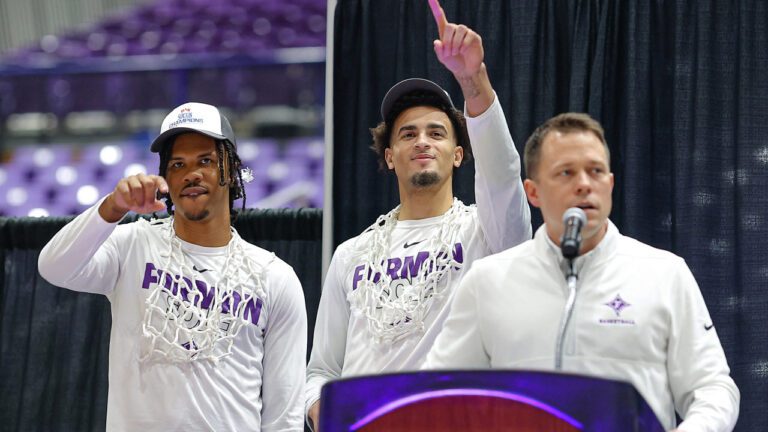 two basketball players and coach speaking at a podium on selection sunday